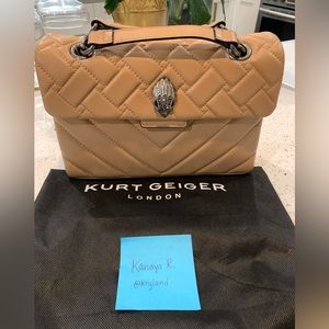 This is a medium sized beige Kurt Geiger Purse that has only been worn once!